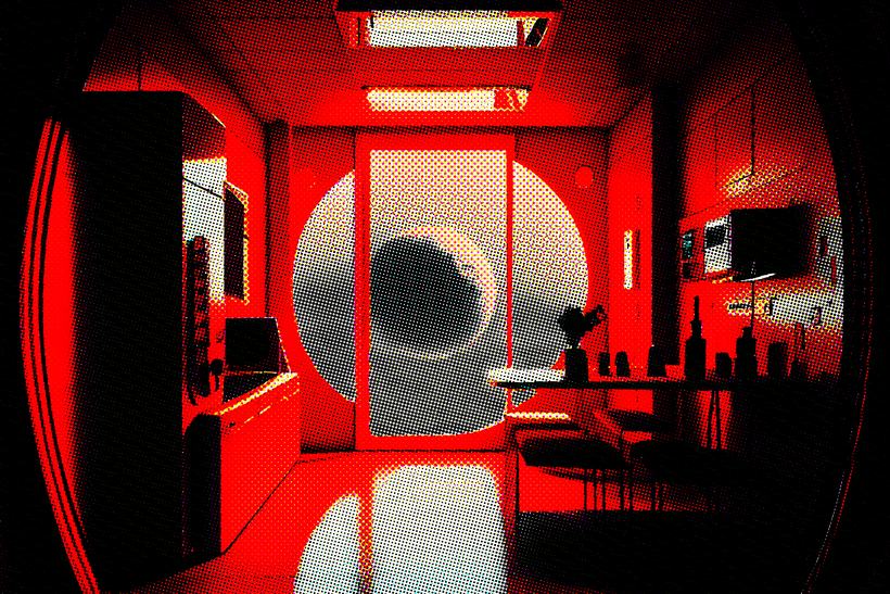 A red-lit chamber with a circular porthole showing a grey sphere beyond.